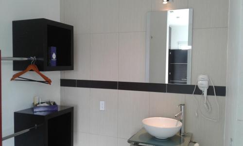 a bathroom with a sink and a mirror at Rancho Macloy Hotel Spa & Social Events in Yautepec