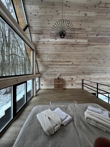 a bedroom with a bed with two towels on it at Tysha House in Ternopil