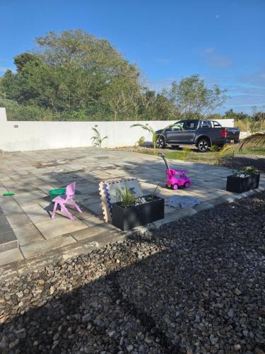 a parking lot with pink plastic chairs and plants at The Palms Property in Long Mountain