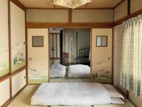 a bedroom with a bed and a large mirror at Hi Song Villa in Otaru