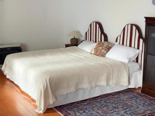 a bedroom with a large white bed with wooden headboards at Hi Song Villa in Otaru