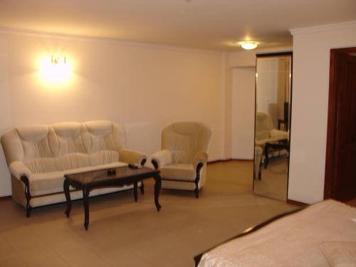a living room with a couch and chairs and a table at Hotel Klisura in Sunny Beach