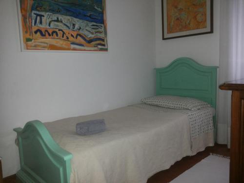 a bed in a room with a green bed frame at B&B Castellani in Venice-Lido