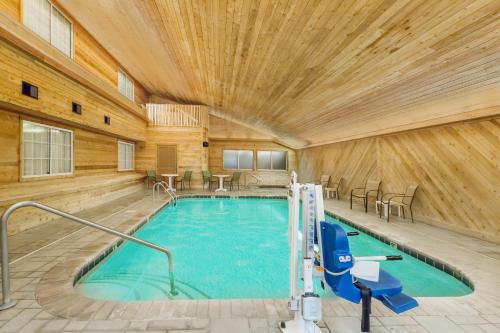 a pool in a room with a wooden ceiling at Americas Best Value Inn & Suites; Atlantic Inn & Suites in Atlantic