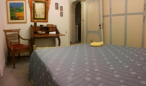 a bedroom with a bed and a desk and a chair at B&B Castellani in Venice-Lido
