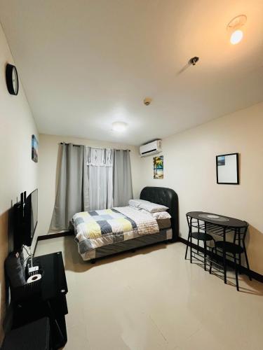 a bedroom with a bed and a table in it at Richloves Haven in Suba