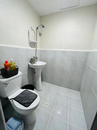 a bathroom with a toilet and a sink at Richloves Haven in Suba