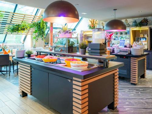 a buffet in a restaurant with food on a counter at Novotel Paris Centre Bercy in Paris