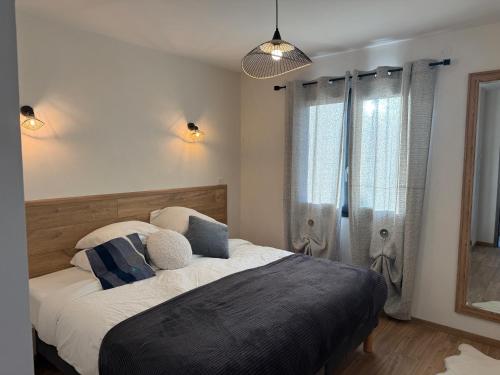 a bedroom with a large bed and a window at The Eagle's Nest - cosy chalet for two in Jarjayes
