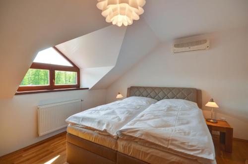 a bedroom with a large bed in a attic at Amenity Hotel & Resort Česká Kanada in Nová Bystřice