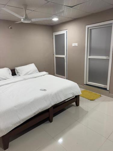 a bedroom with a large bed and a window at Jp Resorts in Muttupet