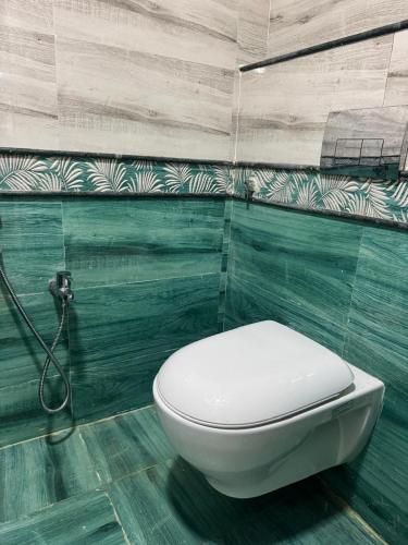 a bathroom with a white toilet in a room at Jp Resorts in Muttupet