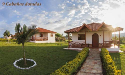 a house with a palm tree in the middle of a yard at Hacienda Sanmiguel de la Prada in Los Santos