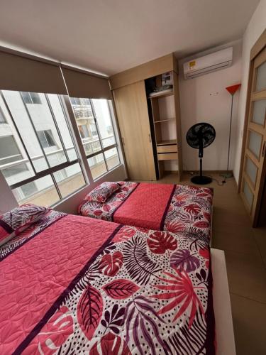 a bedroom with two beds and a window at Alessandro estilo italiano in Cartagena de Indias