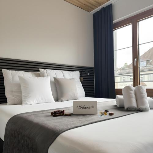 a large white bed with a box on top of it at RS Boardinghouse Aparthotel mit Charme und Hotelservice in St. Gallen