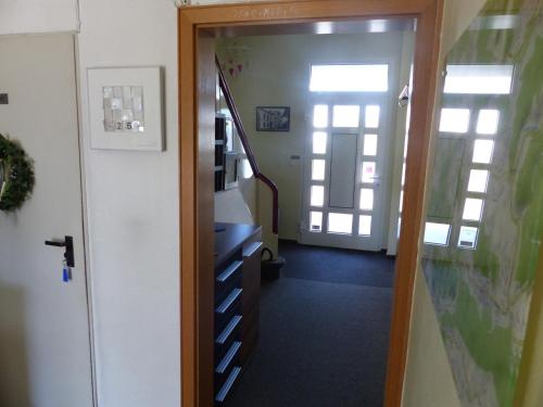 a hallway with a stairway leading into a room at Hotel Theile garni in Gummersbach