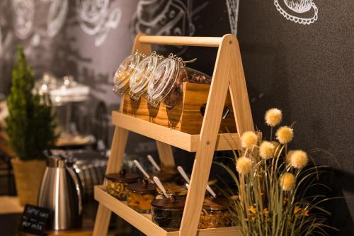 a wooden shelf with a bunch of bangles on it at Mercure Bucharest Cantemir in Bucharest