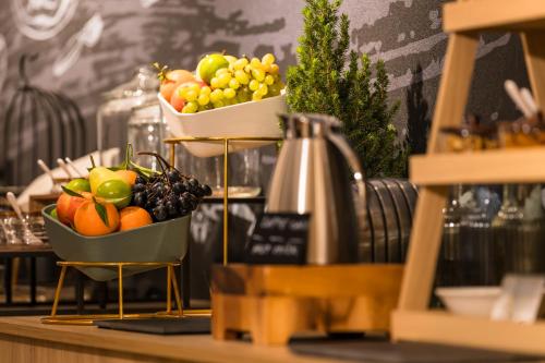 two baskets of fruit sitting on a counter at Mercure Bucharest Cantemir in Bucharest