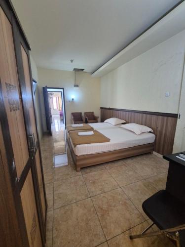 a bedroom with a bed and a couch in it at Halim Living in Sukarami