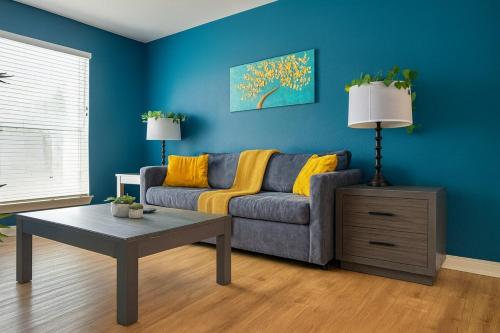 a living room with a couch and a table at Dreamy 2BR Home with BQQ I Gym & Pool in Houston