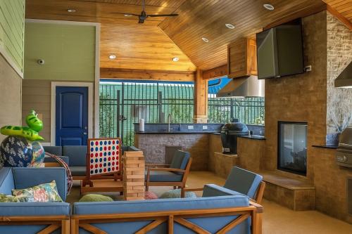a living room with a blue couch and chairs at Dreamy 2BR Home with BQQ I Gym & Pool in Houston
