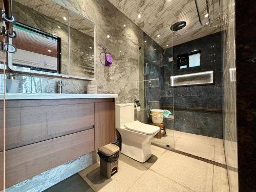 a bathroom with a toilet and a sink and a shower at Navasharada's White Sand Beach House in Udupi