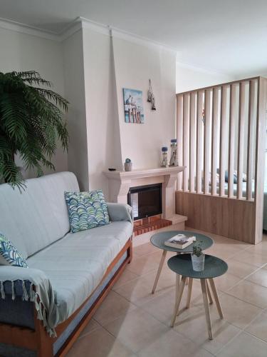 a living room with a couch and a table at Filipe´s House in Baleal