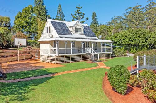 a house with solar panels on the roof at Mountain Escape Cozy 3-Bedroom Retreat with Outdoor Entertaining in North Tamborine