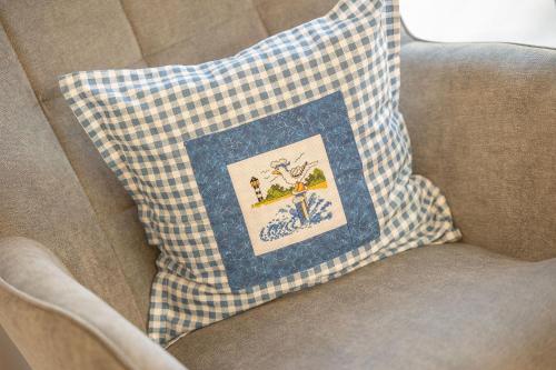 un coussin bleu et blanc sur une chaise dans l'établissement Alte Fischfabrik SeePerle, à Lauterbach