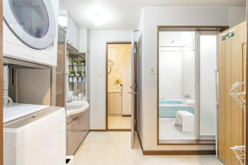 a bathroom with a sink and a tub at Cozy Stay Kamui in Asahikawa