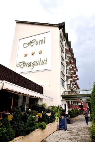 a sign for a hotel on the side of a building at Hotel Dragului in Predeal