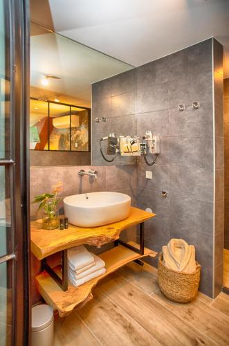 a bathroom with a sink and a mirror at Boutique Hotel, Restaurant & Wellness Westerburcht in Westerbork