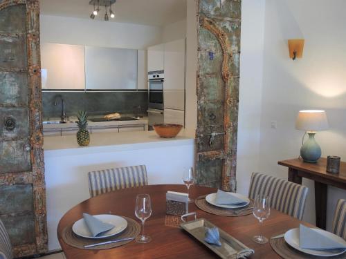 a dining room with a table and a kitchen at Residenza Golf Parco by Fewotessin in Ascona