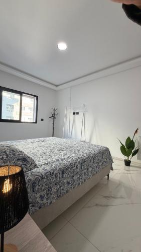 a bedroom with a bed in a white room at Premium Suite - Ain zaghouen - proche aeroport - linge hotel in El Aouina Station