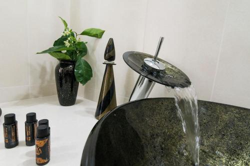 a bathroom sink with a water fountain at Residenza La Nivera in Miglionico