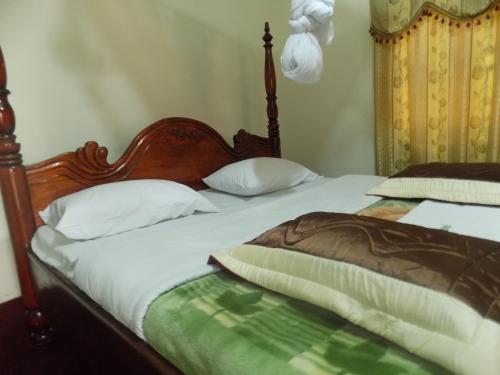 a bedroom with two beds with white pillows at Townview Hotel Mubende in Mubende