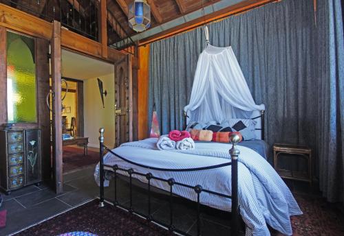 a bedroom with a bed with a canopy at Buddha Villa in Arillas