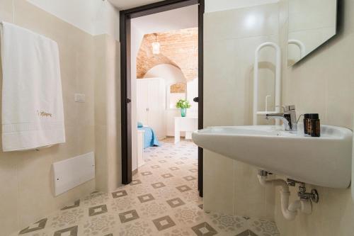 a bathroom with a sink and a mirror at Residenza La Nivera in Miglionico