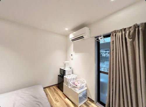 a room with a bed and a air conditioner at Sunny Haven in Tokyo in Tokyo