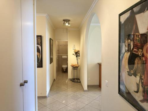 a hallway with a toilet and a painting on the wall at Portofino by Fewotessin in Brissago