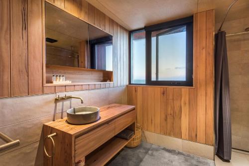 a bathroom with a sink and a window at Native Dog Cabin in Bremer Bay