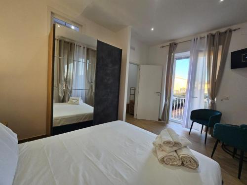 a hotel room with a bed and a mirror at Olimpo Caserta in Caserta
