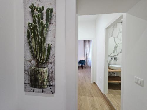 a room with a cactus painting on the wall at Olimpo Caserta in Caserta