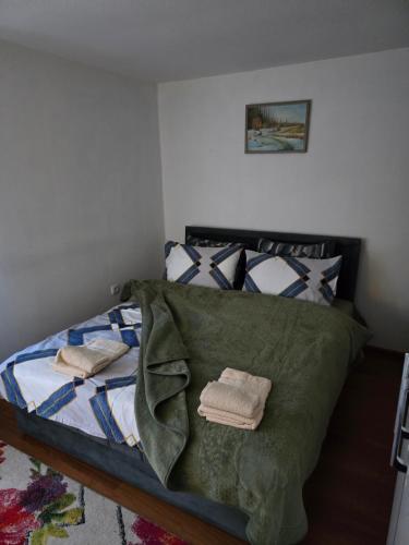 a bedroom with a bed with two towels on it at Premecki konak in Čačak