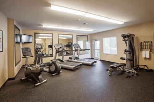 a gym with treadmills and machines in a room at Sonesta Simply Suites Arlington Entertainment District in Arlington