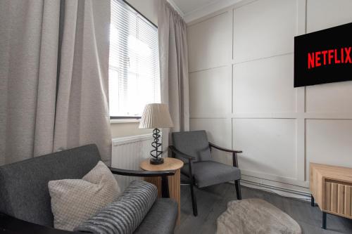 a living room with a couch and a chair at Luxury Studio 1 Bedroom Apartment in Chatham