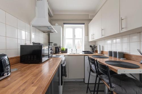 a large kitchen with a wooden counter top and a counter top at Luxury Studio 1 Bedroom Apartment in Chatham