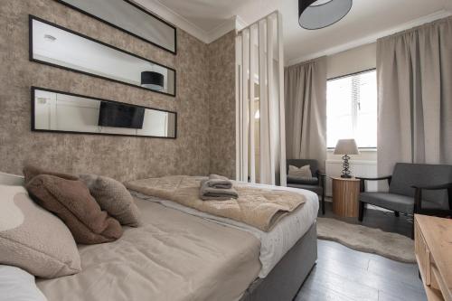 a bedroom with a bed and a tv on the wall at Luxury Studio 1 Bedroom Apartment in Chatham