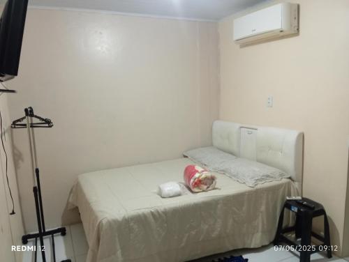 a small room with a bed in the corner at kitnet A in São Luís