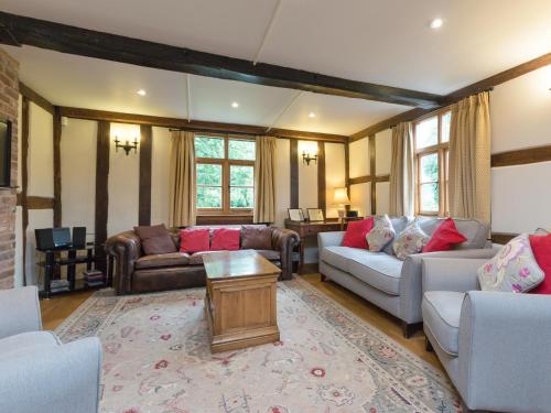 a living room with two couches and a table at Brook House in Mathon